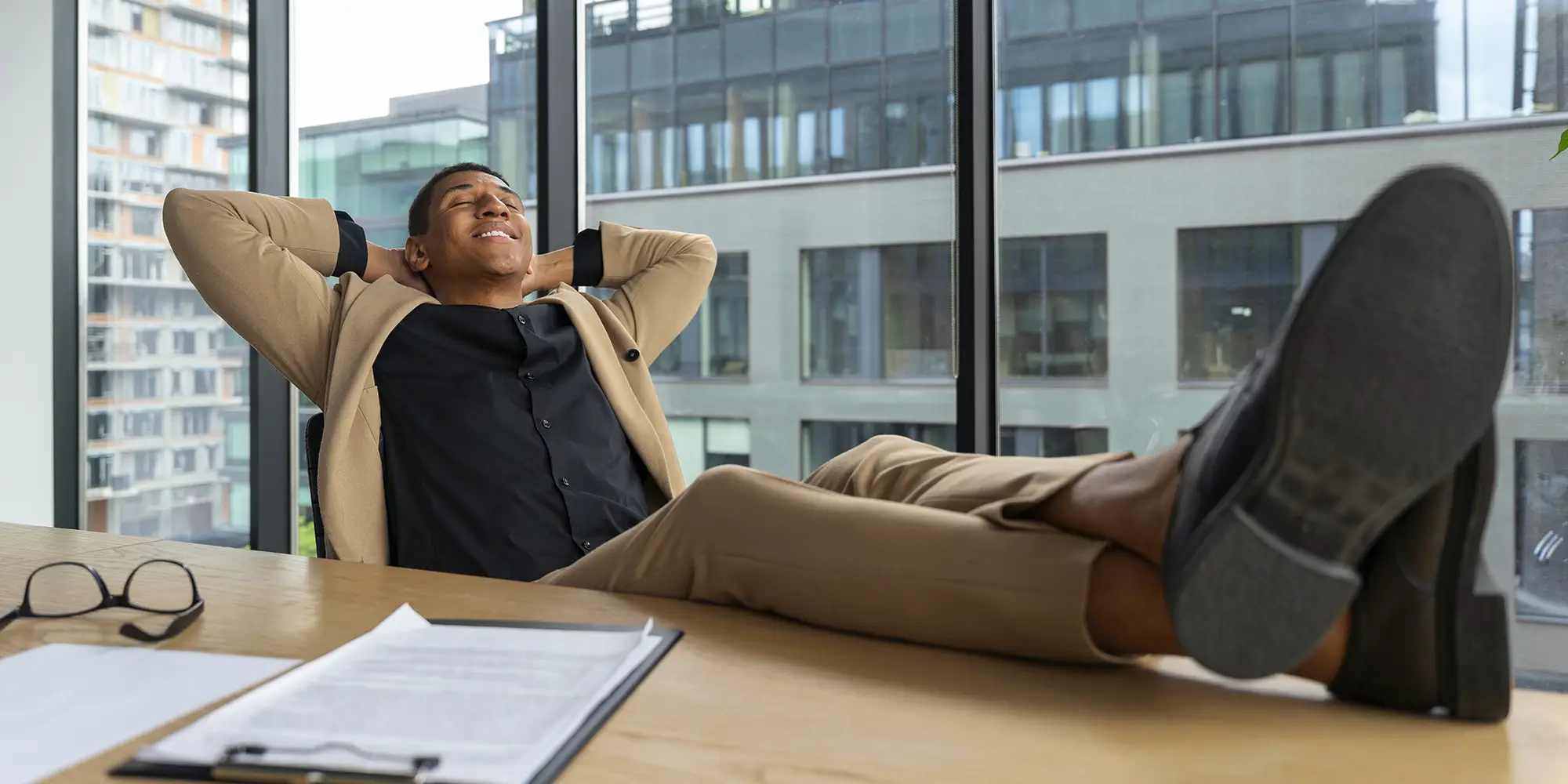 Man in an office with is feet up on his desk