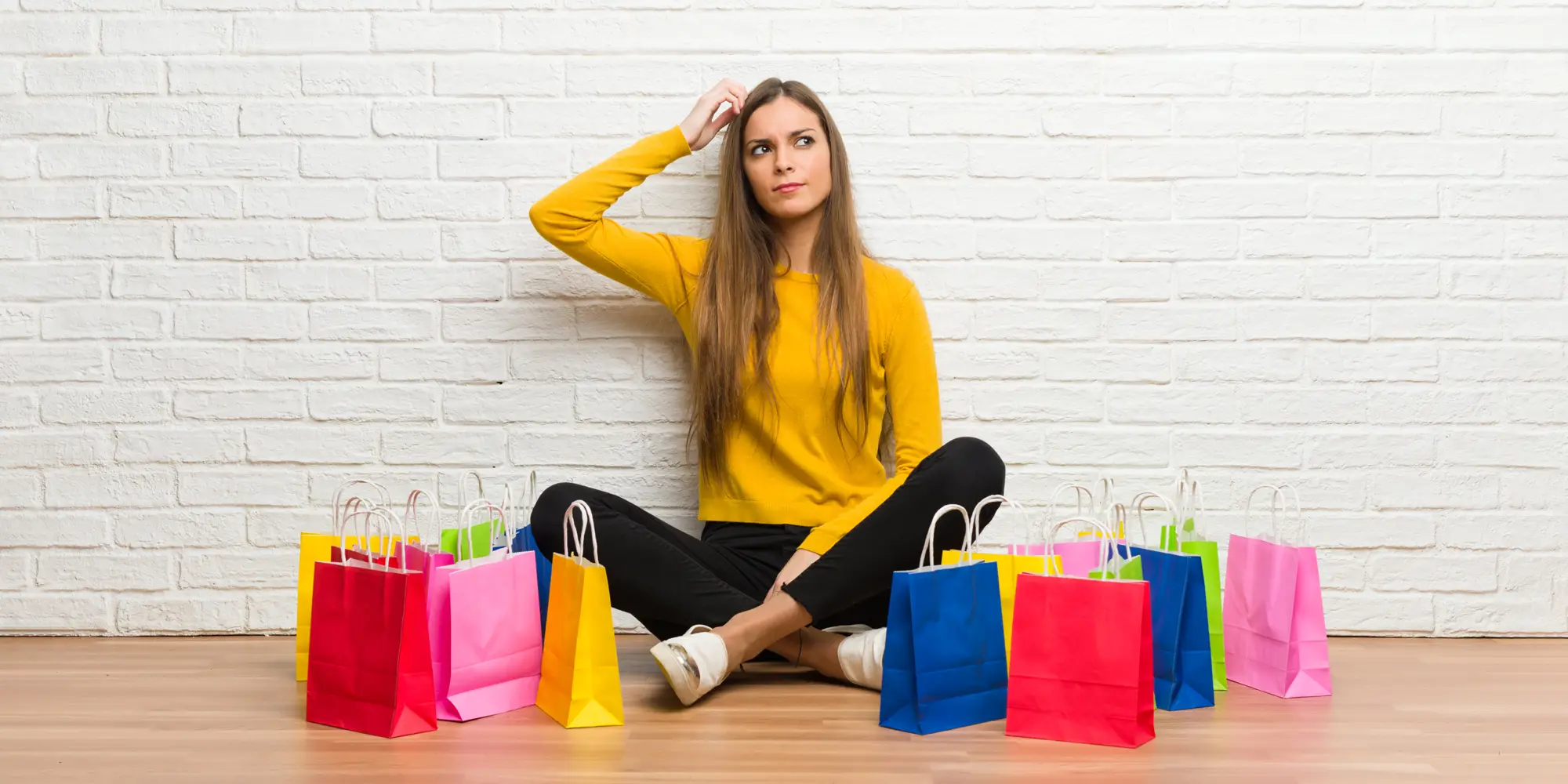 pensive woman surrounded by shopping bags