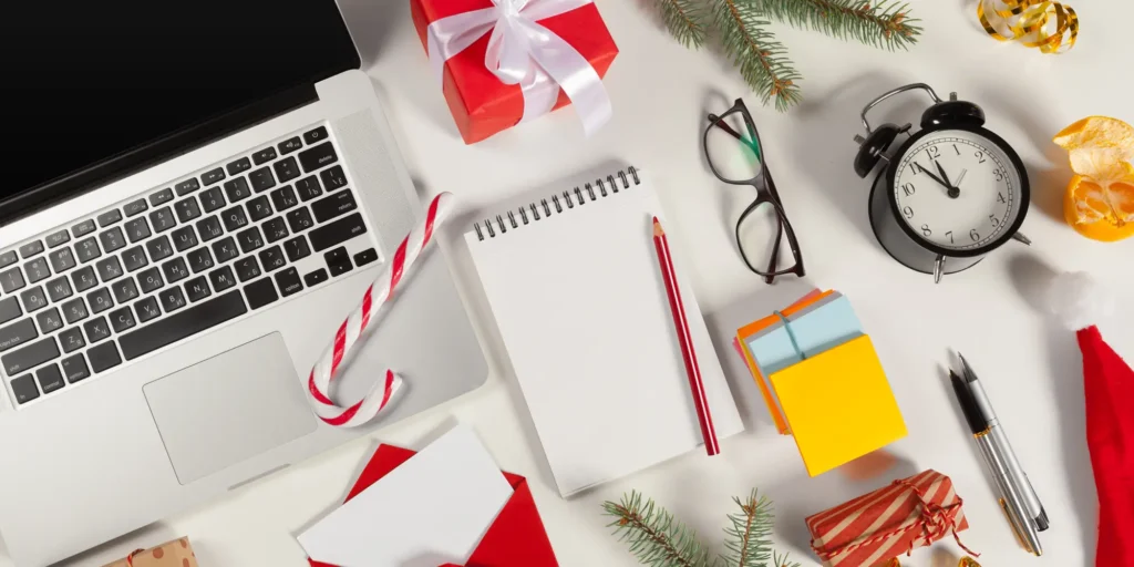 desk with computer and holiday-themed items in preparation for retail holiday season