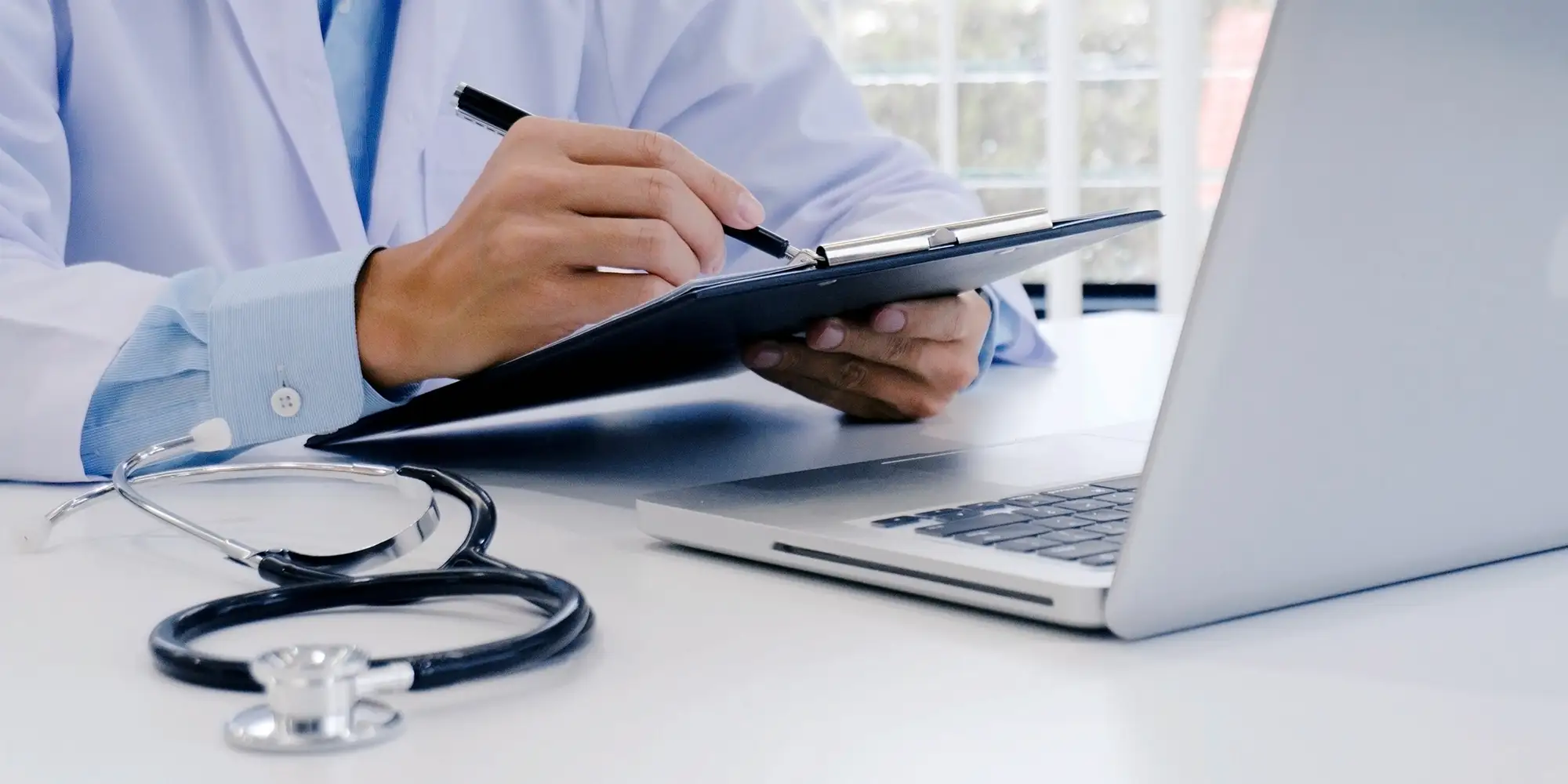 doctor with stethoscope and computer doing a wellness check on website