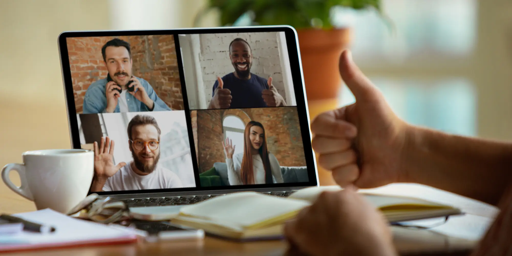 laptop screen with four people on a video conference