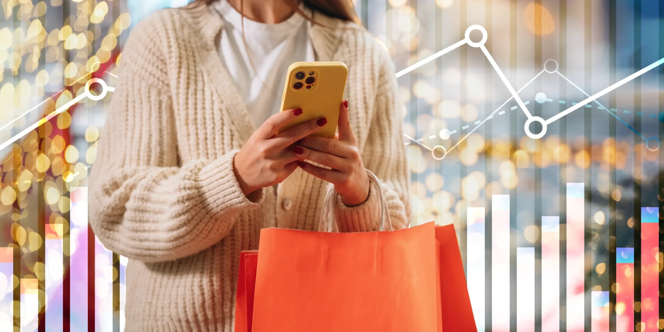 woman holding a shopping bag and mobile phone