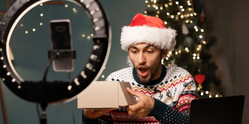 social media influencer unboxing a product with festive holiday elements