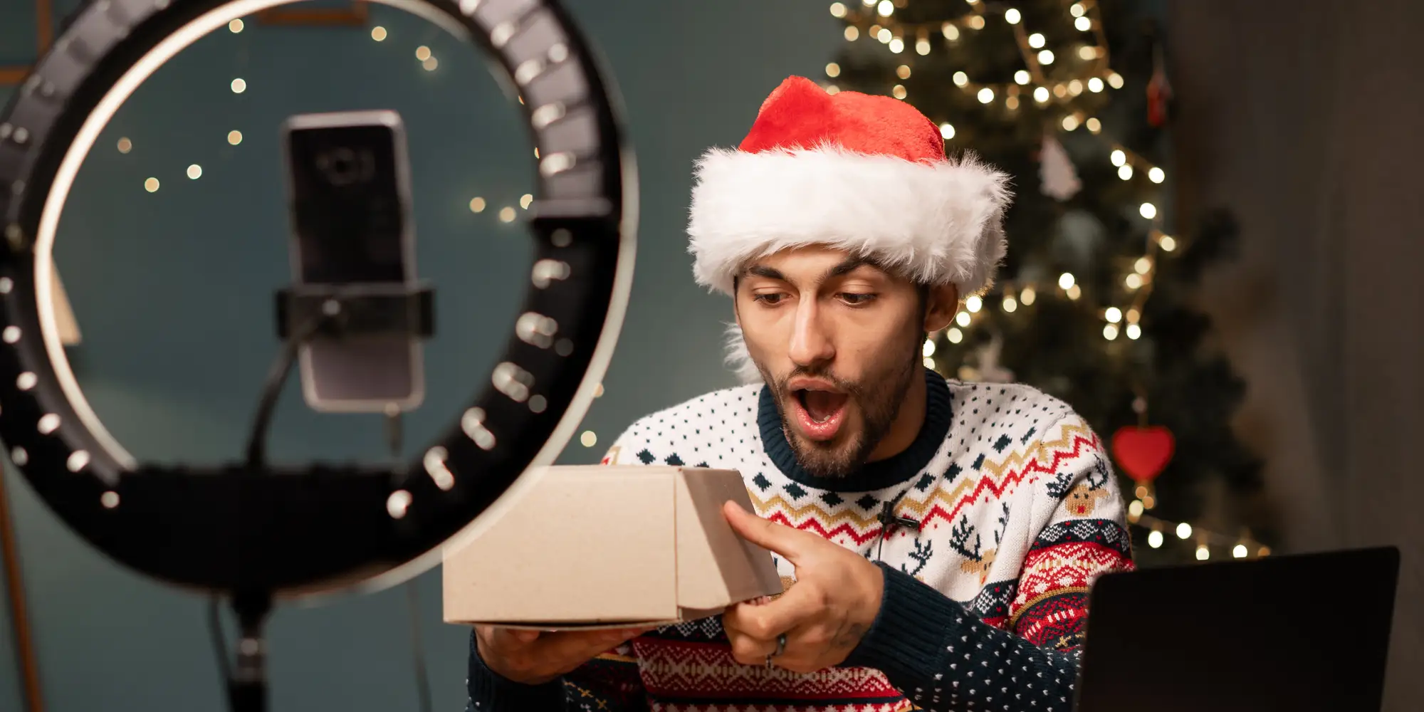 social media influencer unboxing a product with festive holiday elements